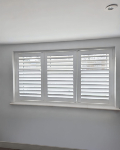 UK Made PVC Plantation Shutters for Bedroom Beautifully fitted UK made white PVC plantation shutters installed in a bedroom, custom made for a perfect fit.