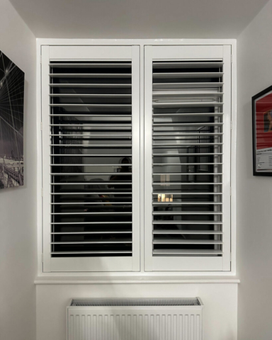 UK Made PVC Plantation Shutters for Box Bedroom Beautifully fitted UK made white PVC plantation shutters installed in a box bedroom by Scarlet Blinds in Manchester, custom made for a perfect fit.