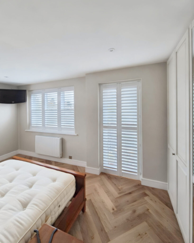 UK Made PVC Plantation Shutters for Bedroom Door and Side Window Beautifully fitted UK made white PVC plantation shutters installed on a bedroom door and side window by Scarlet Blinds in Manchester, custom made for a perfect fit.