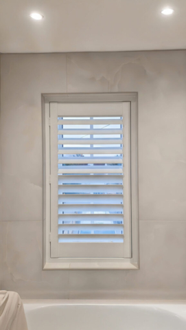UK Made PVC Plantation Shutters for Bathroom Window in Middleton Bathroom window fitted with UK made white PVC plantation shutters by Scarlet Blinds and Shutters in Middleton, custom made for a perfect fit.