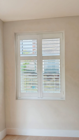 UK Made PVC Plantation Shutters for Hallway Window Beautifully fitted UK made white PVC plantation shutters installed on a hallway window by Scarlet Blinds in Manchester, custom made for a perfect fit.