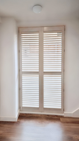 White PVC Shutter Fitted to Full Back Window White PVC plantation shutter fitted across a full back window, providing privacy and light control.
