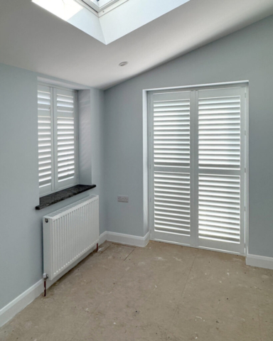 White PVC Plantation Shutters Fitted to Patio Door and Adjacent Window White PVC plantation shutters fitted to a patio door by Scarlet Blinds and Shutters with an additional matching shutter installed on the adjacent window.