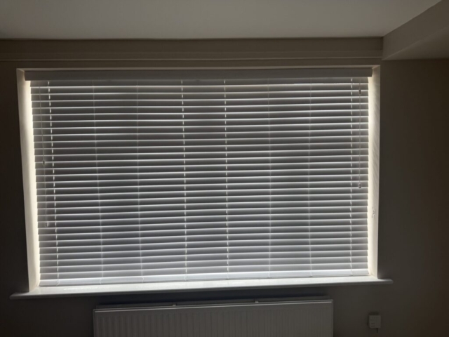 Fully Closed Venetian Blind in Newton Heath Living Room Venetian blind fully closed on a living room front window in Newton Heath, installed by Scarlet Blinds and Shutters