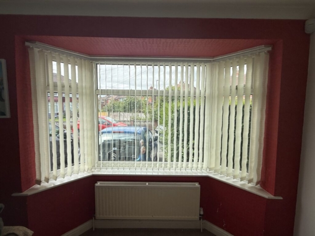 vertical-blinds-89mm-dolphin-cream-open-droylsden-manchester 89mm dolphin cream vertical blinds open in a bay window in Droylsden Manchester