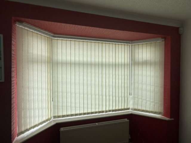 vertical-blinds-89mm-dolphin-cream-closed-droylsden-manchester 89mm dolphin cream vertical blinds closed in a bay window in Droylsden Manchester