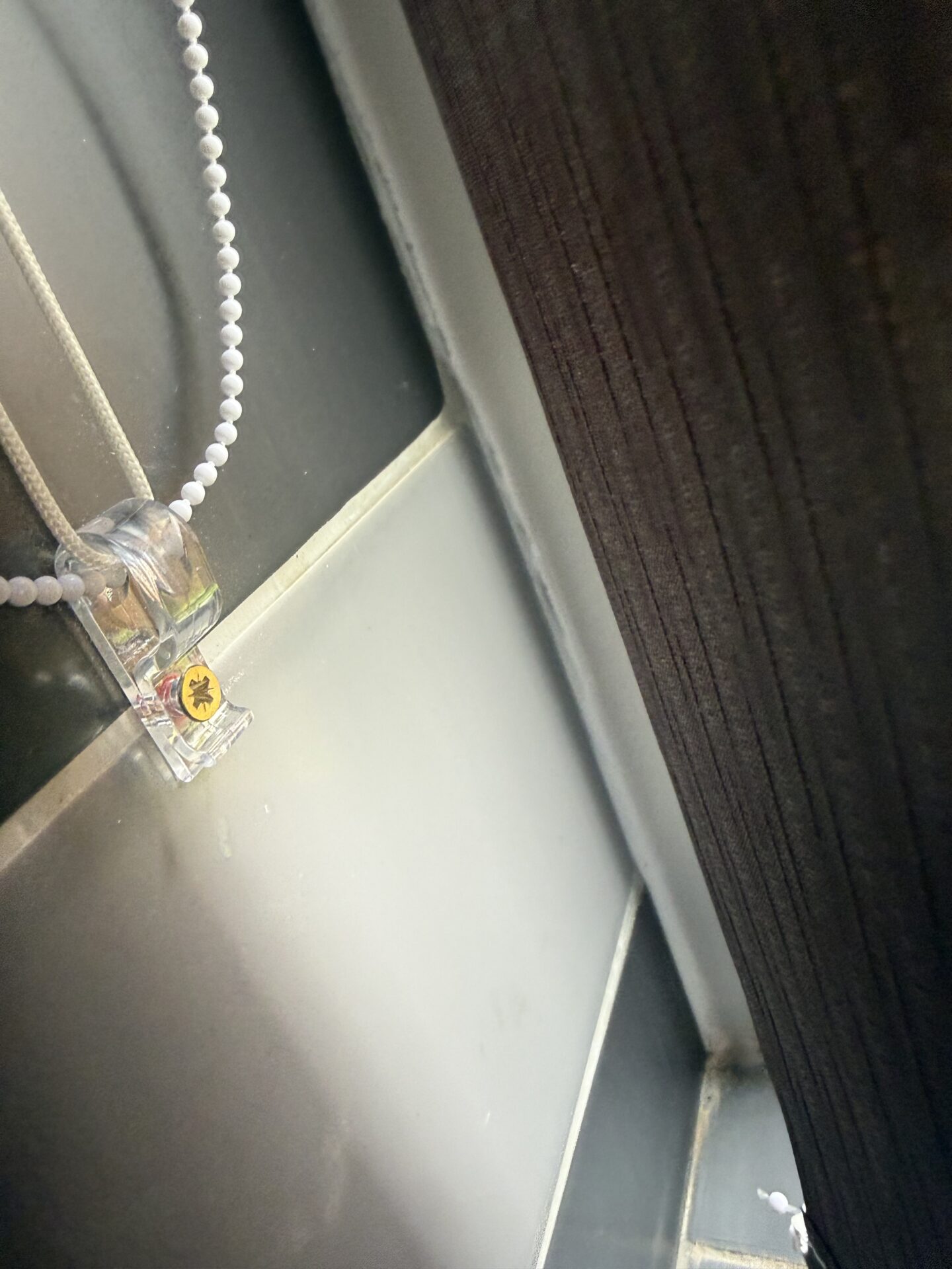 Child safety clip fitted to vertical blinds by Scarlet Blinds & Shutters in Blackley, Manchester