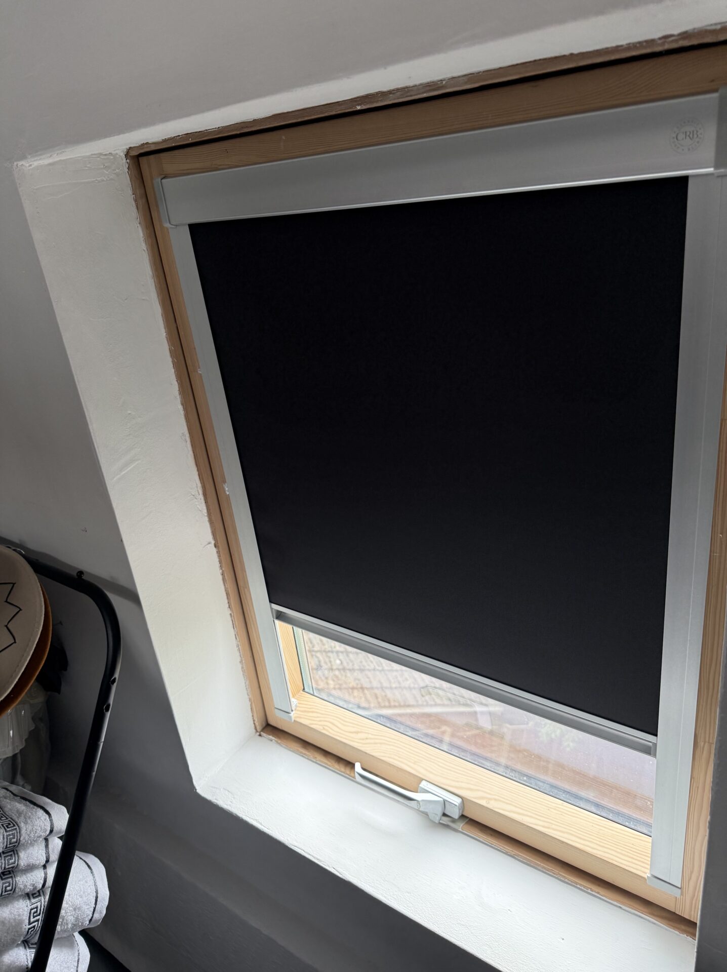 Black OptiLight skylight blind half open fitted by Scarlet Blinds and Shutters in Little Lever, Bolton